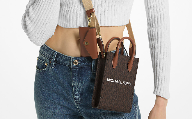A Woman Wearing Michael Kors Mirella Extra Small Smartphone Crossbody Bag