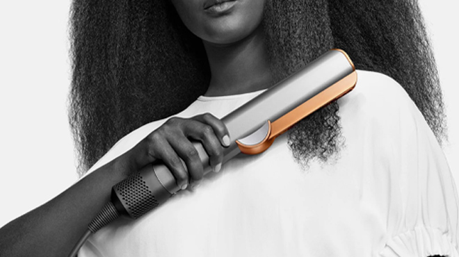 Lady holding Dyson Airstrait Straightener