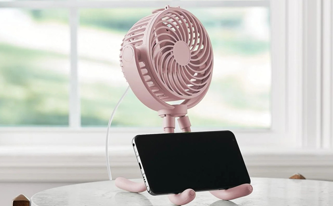 Mainstays Tripod Fan in Pink Color with Smartphone on it