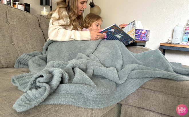 Mom and Daughter Covered with the Barefoot Dreams CozyChic Stacked Rib Border Blanket