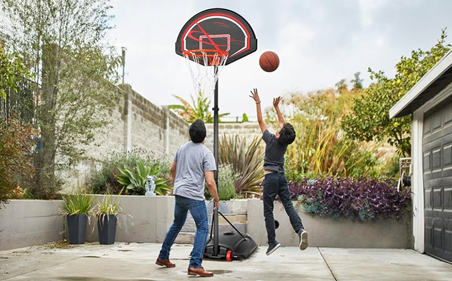 People Playing Basketball with a Portable Basketball Hoop