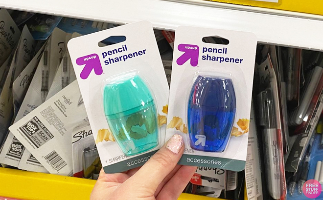 Person Holding two Up Up Sharpeners