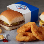 White Castle Original Sliders on a Table with Fries and Chicken Rings