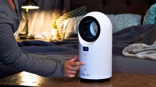 a Person Touching LivePure Turbine Vortex Oscillating 1500 Watt Heater with Filtration