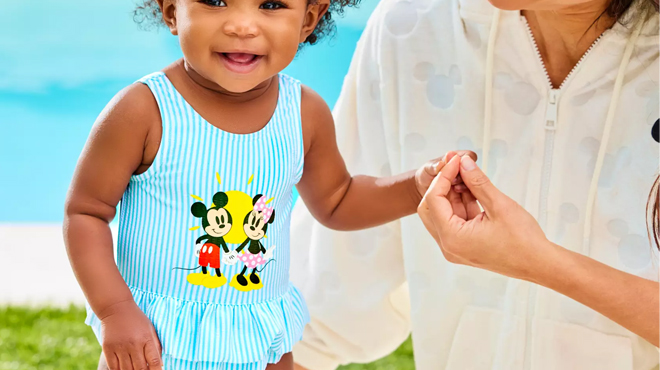 A Baby Wearing a Disney Mickey Minnie Baby Swimsuit