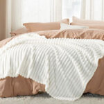 A Bedsure White Fleece Twin Blanket on a Bed