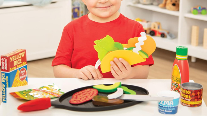 A Boy Playing with Melissa Doug Fill Fold Taco Tortilla Set