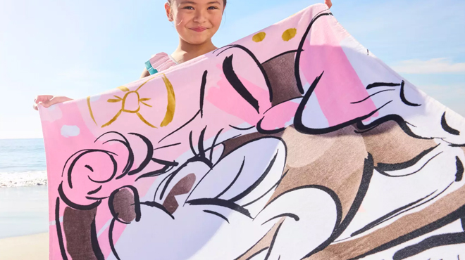 A Girl Holding a Disney Minnie Mouse Kids Beach Towel