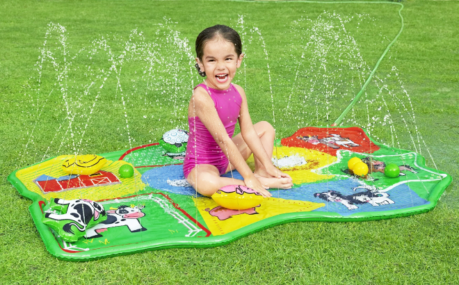 A Girl Playing on Lil Barnyard Multicolor Sprinkler Splash Pad