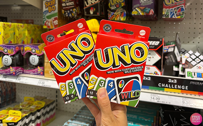 A Hand Holding Two Sets of UNO Cards