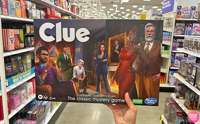 A Hand Holding Clue Board Game