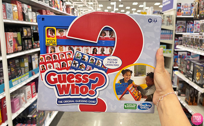 A Hand Holding Guess Who Board Game