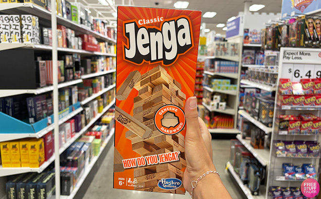 A Hand Holding Jenga Board Game