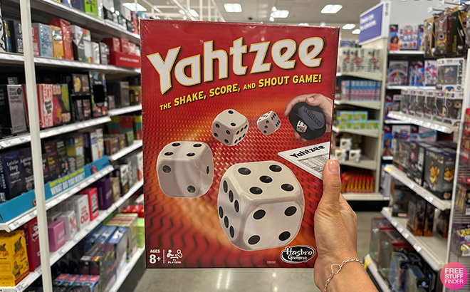 A Hand Holding Yahtzee Board Game 