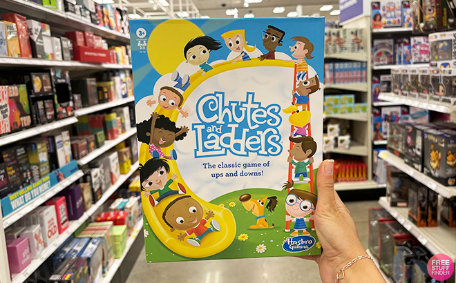 A Hand Holding Chutes and Ladders Board Game