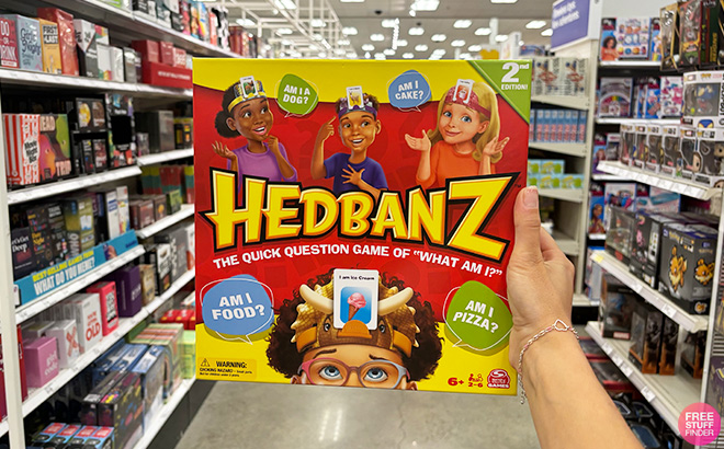 A Hand Holding Hedbanz Board Game