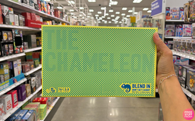 A Hand Holding The Chameleon Board Game