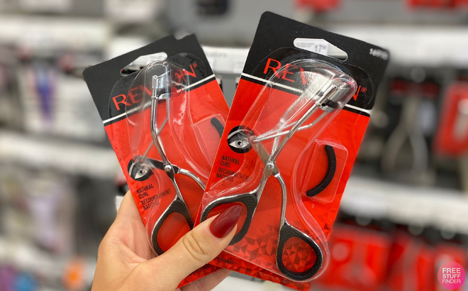 A Hand holding Revlon Lash Curlers