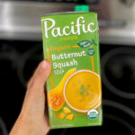 A Hand holding a Carton of Pacific Foods Organic Butternut Squash Soup