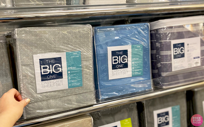 A Hand pointing to The Big One Easy Care Twin Sheet Set on a Shelf 