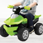 A Kid Riding the Adventure Force Green Terrain Racer ATV