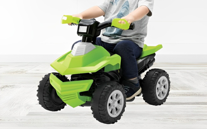 A Kid Riding the Adventure Force Green Terrain Racer ATV