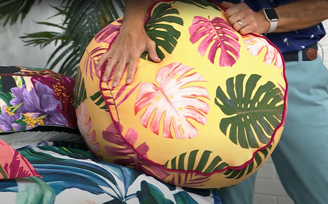 A Man Holding South Street Loft 22 Inch Round Pouf