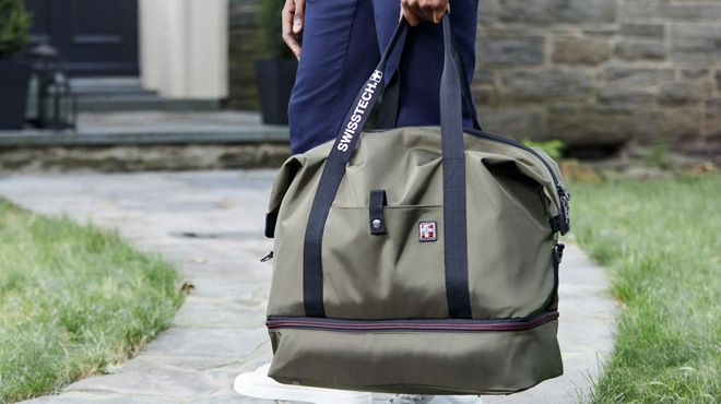 A Man Holding Swiss Tech Drop Bottom Travel Weekender Duffel