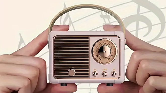 A Man Holding a Retro Wireless Speaker