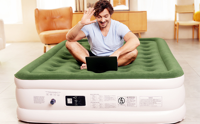 A Man Sitting on Queen Air Mattress with Built in Pump