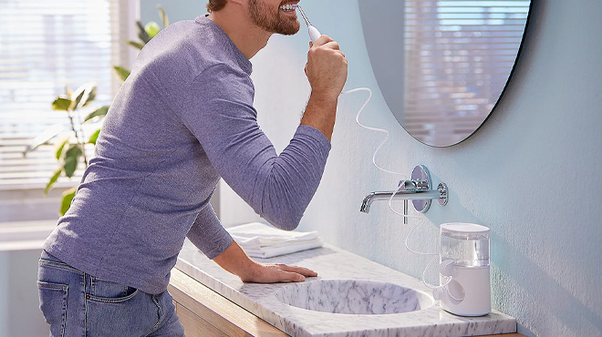 A Man Using the Philips Sonicare Power Flosser 3000