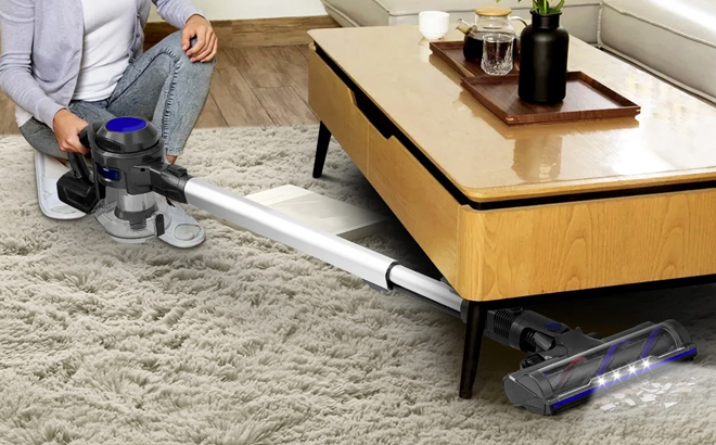 A Person Cleaning a Carpet Using a Moosoo Cordless Vacuum 4 in 1 Lightweight Stick Vacuum