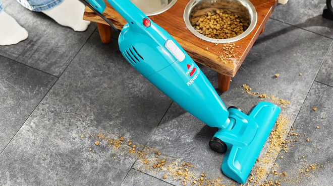 A Person Cleaning a Floor Using a Bissell Stick Bagless Vacuum