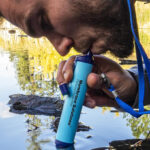 A Person Drinking Water Through Membrane Solutions Straw Water Filter