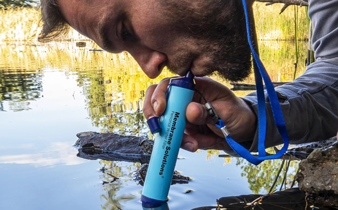 A Person Drinking Water Through Membrane Solutions Straw Water Filter