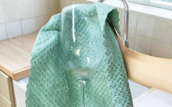 A Person Drying a Glass Using a Microfiber Kitchen Towel