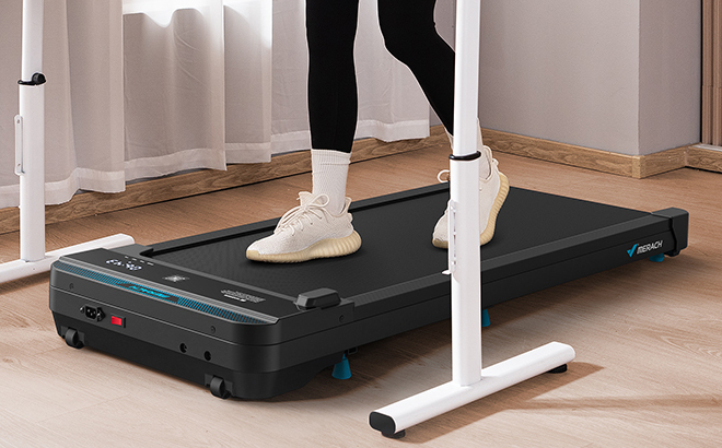 A Person Exercising Using an Under Desk Walking Treadmill