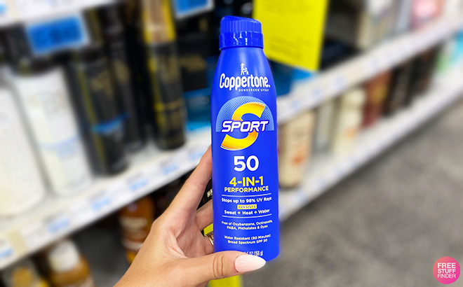 A Person Holding Coppertone Sport Continuous Sunscreen Spray