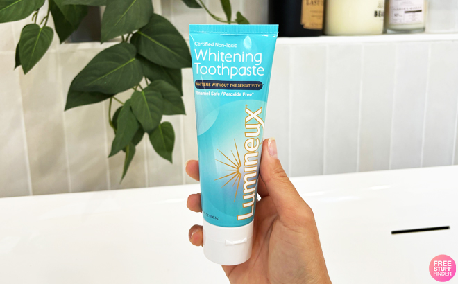 A Person Holding Lumineux Whitening Toothpaste 2 pk