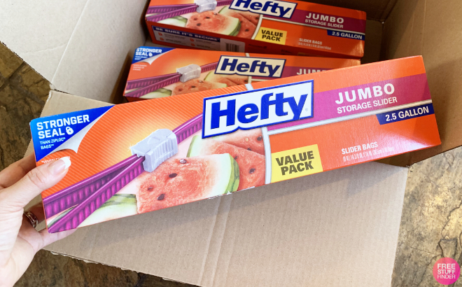 A Person Holding a Box of Hefty Slider Jumbo 2 5 Gallon Storage Bags