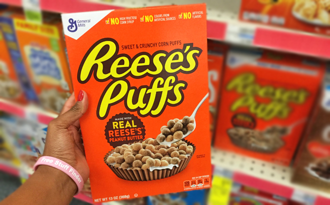 A Person Holding a Box of Reeses Puffs Cereal