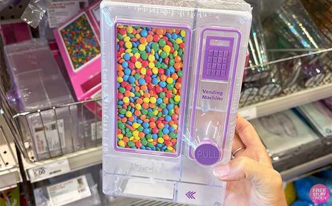 A Person Holding a Desktop Candy Dispenser in Purple at Target