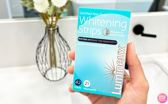 A Person Holding a Lumineux Teeth Whitening Strips 42 Pack