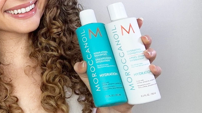 A Person Holding a Moroccanoil Hydrating Shampoo