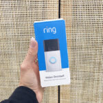 A Person Holding a Ring Video Doorbell