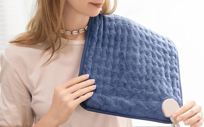 A Person Holding an Electric Heating Pad
