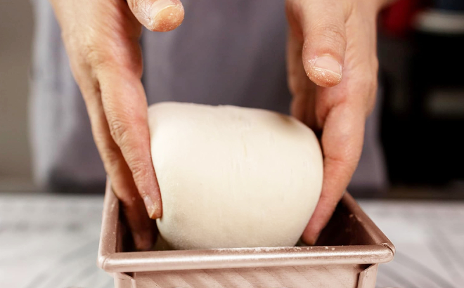 A Person Putting a Doung in Pullman Loaf Pan