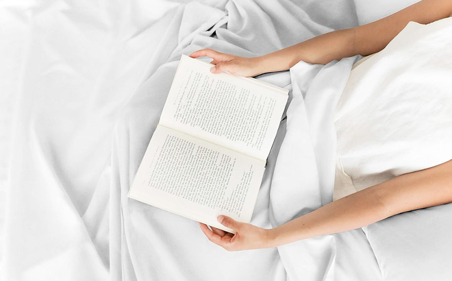 A Person Reading a Book in Bed