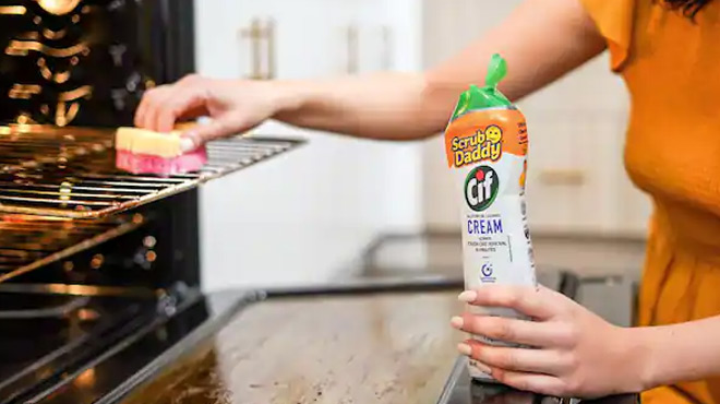 A Person Scrubbing a Grill Using Go Daddy Scrub and Cif Cleaing Cream