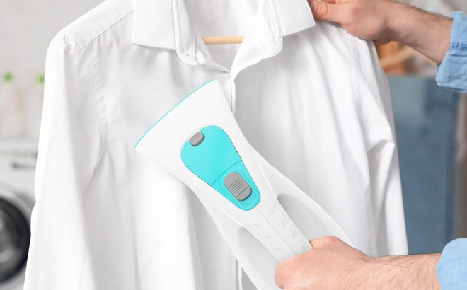 A Person Using a Handheld Garment Steamer